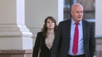 Hannah Gutierrez-Reed, left, with her attorney, Jason Bowles, leaves First District Court, Wednesday, Feb. 21, 2024, in Santa Fe, N.M. (Eddie Moore/The Albuquerque Journal via AP)