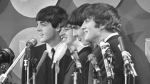 The Beatles address the media in the press room of Kennedy International Airport on their arrival, Feb. 7, 1964 in New York. The Beatles are getting the big-screen biopic treatment in not just one but a Fab Four of movies that will give each band member their own film, all of which are to be directed by Sam Mendes. (AP Photo, File)