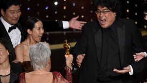 Bong Joon Ho, right, reacts as he is presented with the award for best picture for "Parasite" from presenter Jane Fonda at the Oscars on Sunday, Feb. 9, 2020, at the Dolby Theatre in Los Angeles. (AP Photo/Chris Pizzello)