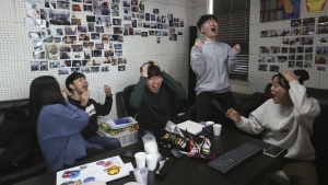 Film club members celebrate as they watch a TV live broadcasting of South Korean director Bong Joon Ho's "Parasite" receiving the award for best picture at the Oscars, at the Yeonsei University in Seoul, South Korea, Monday, Feb. 10, 2020. (AP Photo/Ahn Young-joon)