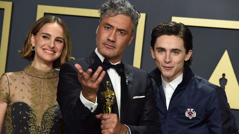 Natalie Portman, from left, Taika Waititi, winner of the award for best adapted screenplay for "Jojo Rabbit", and Timothee Chalamet pose in the press room at the Oscars on Sunday, Feb. 9, 2020, at the Dolby Theatre in Los Angeles. (Photo by Jordan Strauss/Invision/AP)