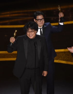 Bong Joon Ho, left, and Han Jin Won accept the award for best original screenplay for "Parasite" at the Oscars on Sunday, Feb. 9, 2020, at the Dolby Theatre in Los Angeles. (AP / Chris Pizzello) <br> <br> <b>Gallery sponsored by Wonder Bread</b>