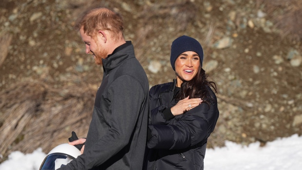 Prince Harry and Meghan Markle, the Duke and Duchess of Sussex, walk together after Harry slid down the track on a skeleton sled a second time while attending an Invictus Games training camp, in Whistler, B.C., Thursday, Feb. 15, 2024. THE CANADIAN PRESS/Darryl Dyck