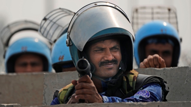 Rapid Action Force personnel guard a major highway at Singhu near New Delhi to stop thousands of protesting farmers from entering the capital, India, Tuesday, Feb.13, 2024. Farmers, who began their march from northern Haryana and Punjab states, are asking for a guaranteed minimum support price for all farm produce. (AP Photo/Manish Swarup)