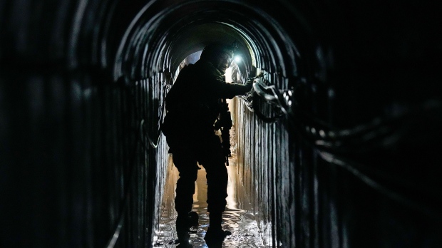 Lt. Col. Ido, whose last name was redacted by the military, walks inside a tunnel underneath the UNRWA compound, where the military discovered tunnels in the main headquarters of the U.N. agency that the military says Hamas militants used to attack its forces during a ground operation in Gaza, Thursday, Feb. 8, 2024. (AP / Ariel Schalit)