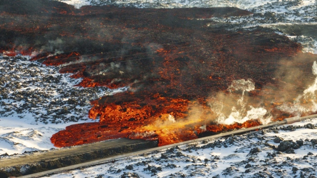 A view of lava hitting the hot water pipeline flowing on the road leading to the Blue Lagoon, in Grindavík, Iceland, Thursday, Feb. 8, 2024.<br><br>
A volcano in southwestern Iceland has erupted for the third time since December and sent jets of lava into the sky. The eruption on Thursday morning triggered the evacuation the Blue Lagoon spa which is one of the island nation’s biggest tourist attractions. (AP Photo /Marco Di Marco).