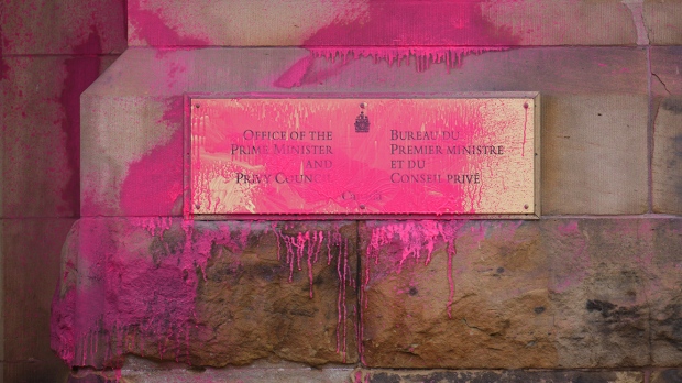 Pink paint covers a sign on the entrance to the prime minister's office on Wellington Street in Ottawa on Wednesday, Feb.7, 2024. (Sean Kilpatrick/THE CANADIAN PRESS)