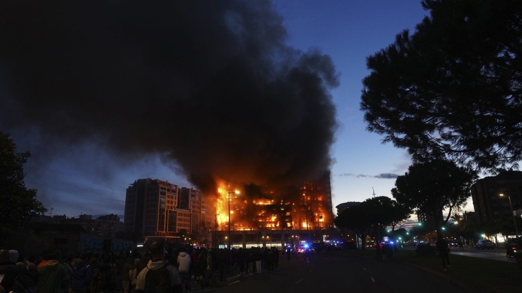 A housing block burns in Valencia, Spain, Thursday, Feb. 22, 2024. The cause of the fire is unknown and if there are any victims. (AP Photo/Alberto Saiz)